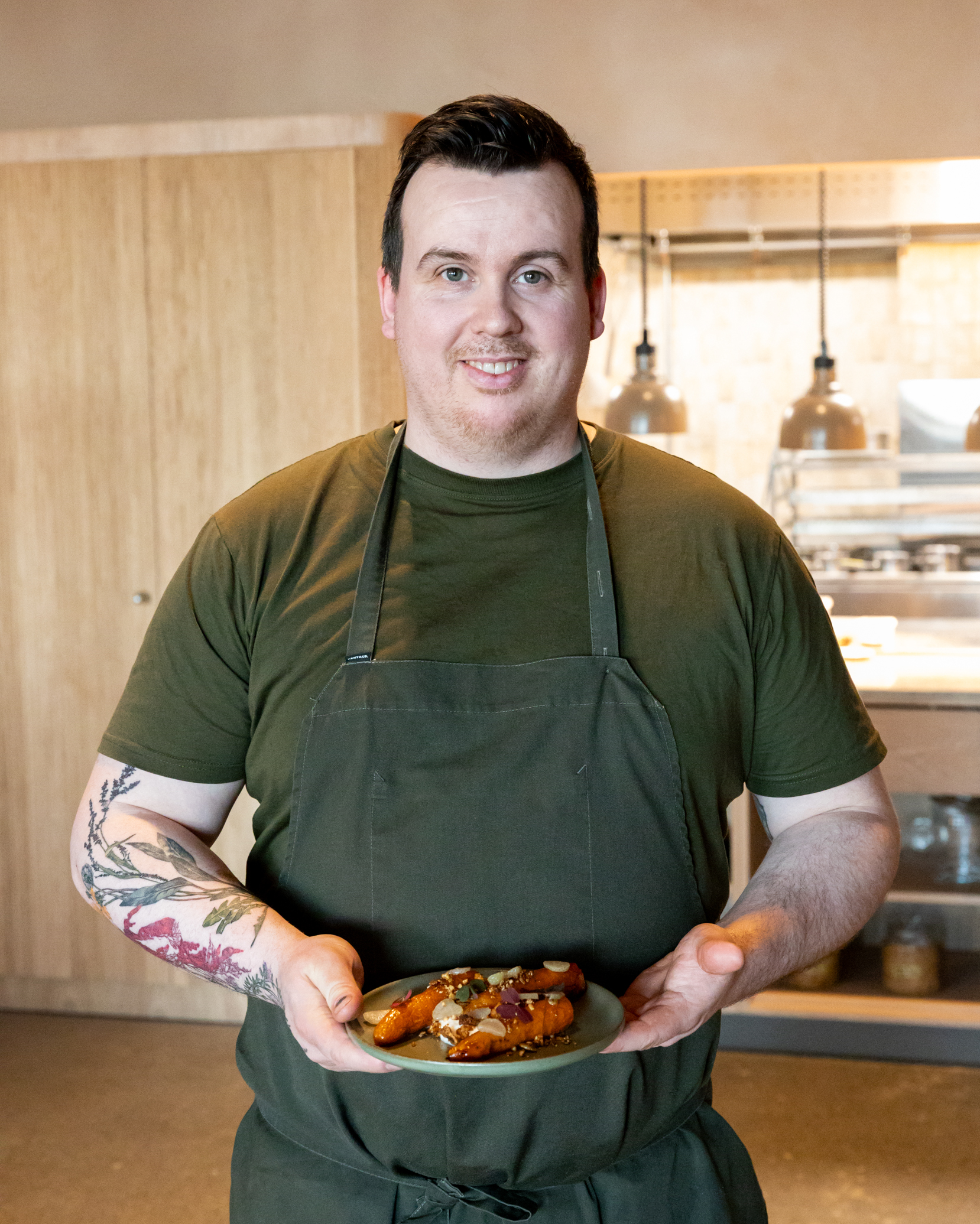 Chef Gísli Matt presenting a seasonal dish at Ylja restaurant in Laugarás