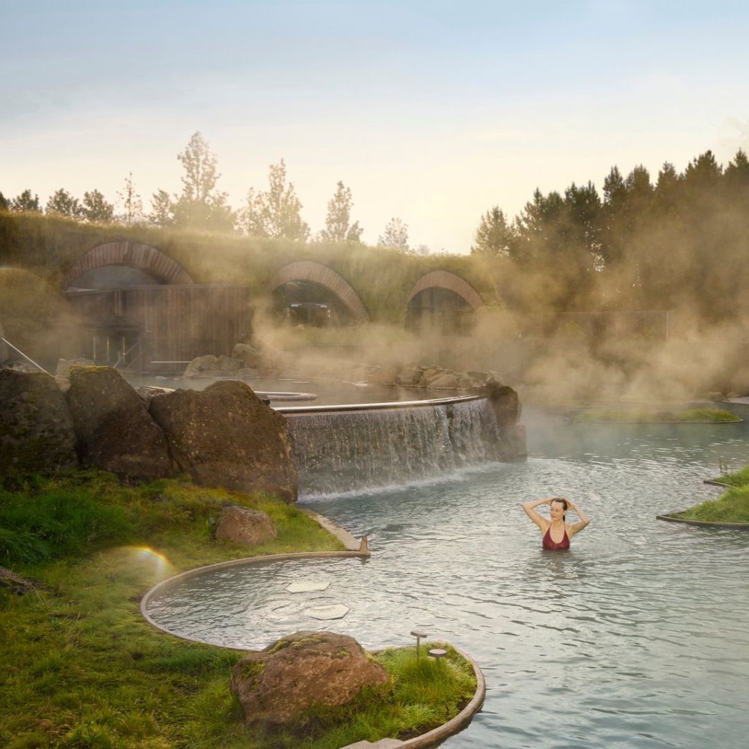 Guest relaxing in the geothermal waters at Laugarás Lagoon